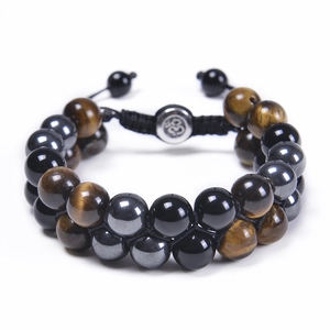 Detail of tiger eye and obsidian beads with Om symbol on woven double-layer bracelet