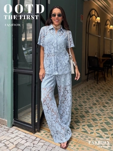 Detail view of light blue lace three-piece set with floral crochet embroidery and wide-leg pants