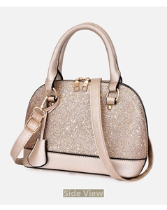 Close-up of champagne gold glitter shell bag with gold hardware and top handles