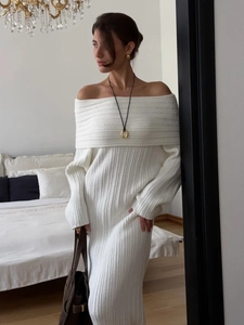 Detail of high-density ribbed knit texture on a white off-shoulder long-sleeve dress