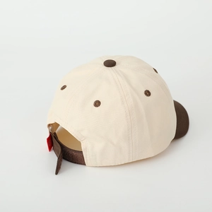 Detail of kids baseball cap with adjustable velcro strap and red smiley face tag