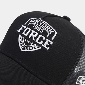 Detail of vintage New York 1985 embroidery on black breathable mesh trucker hat