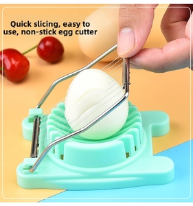 Action shot showing the manual egg slicer pressing through a hard-boiled egg with ease