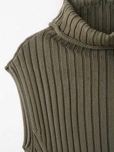 Close-up of olive green turtleneck knit vest showing detailed vertical ribbed texture