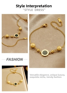Detail of gold chain bracelet featuring roman numeral charm and beads on silk