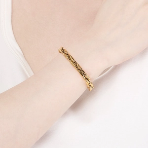 Minimalist gold titanium steel link bracelet with unique bamboo texture on wrist