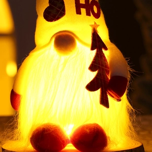 Illuminated Christmas gnome doll with glowing beard, checkered hat, and wooden star tree