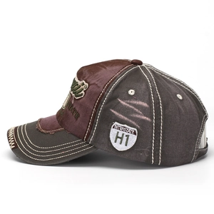 Detail view of washed denim baseball cap featuring distressed edges and a shield patch