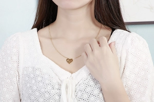 On-neck view of a gold double-layer heart MOM necklace on a model showing proportions