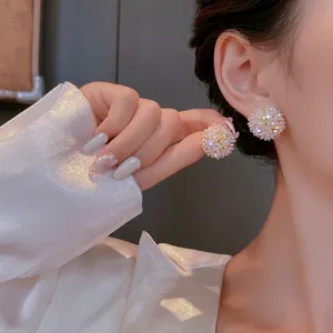 Elegant white hydrangea floral stud earrings with rhinestones shown on model