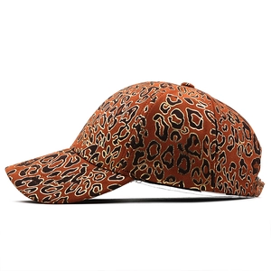 Detail view of leopard print baseball cap with gold foil edges on faux suede fabric