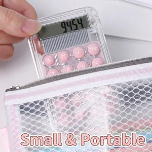 Mini transparent calculator with pink buttons shown being held to emphasize portable size