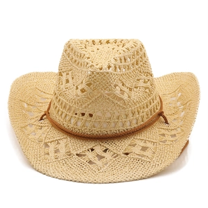 Detail of hand-woven hollow straw texture and brown decorative cord on cowboy sun hat