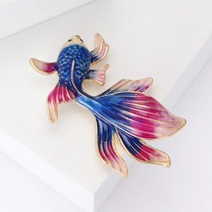Detail of goldfish brooch with colorful enamel gradient on a white display stand