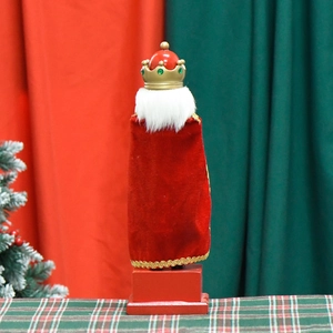 Back view of Nutcracker King doll with red velvet cloak and golden crown decoration