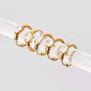 Detail of gold-plated hoop earrings featuring geometric star and rectangle zircons