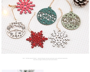 Detailed view of carved wooden Christmas pendants with Merry Xmas text and deer motifs