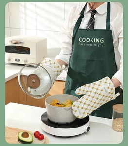 Detail of cream heat-resistant oven mitts with yellow geometric pattern and LOVE LIFE text