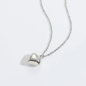 Polished silver heart pendant necklace with elegant cross chain and glossy finish