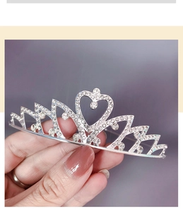 Macro shot of a silver crystal crown tiara with heart detail and sparkling rhinestones