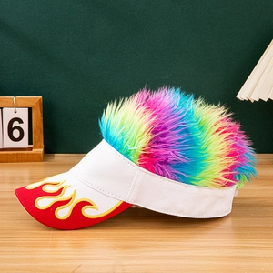Detail shot of white canvas wig hat with rainbow hair and fire embroidery on a wooden table