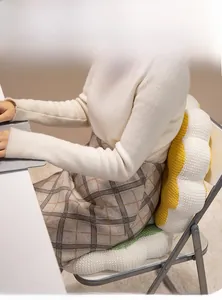 Detail of plush flower seat cushion in yellow and white soft fabric for office chairs