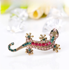 Macro view of lizard brooch with multi-colored rhinestones and gold alloy plating