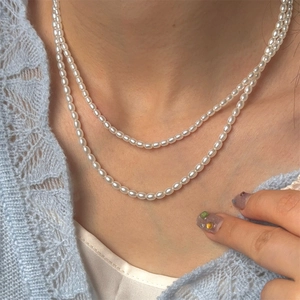 French vintage double-layered pearl necklace with elegant oval beads on a model