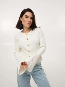 Detailed shot of white ribbed knit cardigan featuring gold buttons and flared sleeves