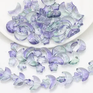 Macro shot of iridescent purple and green gradient star and moon glass beads for DIY jewelry