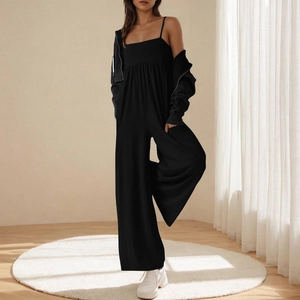 Detail of black square neck jumpsuit with thin straps and soft knit texture finish