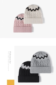 Detailed view of color-block cable knit texture and ribbed fold on four warm winter hats