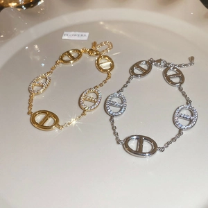 Detailed macro view of gold and silver plated oval link bracelets with sparkling zircons
