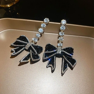 Elegant black bow drop earrings with sparkling rhinestones and gold-plated metal base