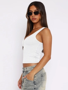 Close-up of white ribbed knit tank top showing the premium fabric texture and low U-neck