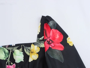 Detail shot of square neckline on floral top with size S label and red blossom prints