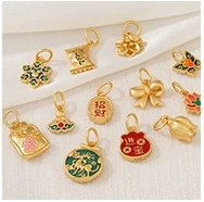 Macro shot of 14k gold-plated floral pendants with colorful enamel lucky charms
