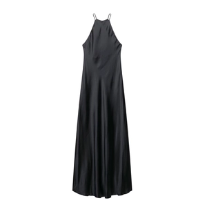 Close-up of black satin halter dress showing smooth glossy silk texture and flowing hemline