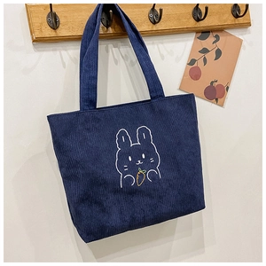 Detail of navy blue corduroy tote bag featuring a cute white rabbit embroidery design