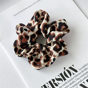 Detail of French vintage leopard print scrunchie on a white magazine background
