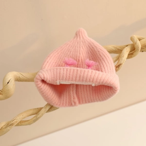 Pink knit baby beanie with cute pom-poms and ear protection for autumn and winter