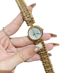 Vintage style gold chain bracelet watch for women with round textured gold dial