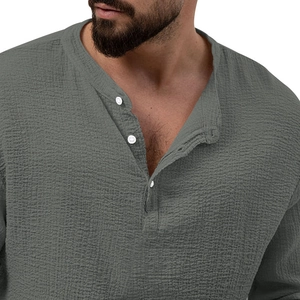 Detail of grey men's long sleeve henley neck shirt with waffle texture and button front