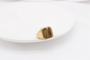 Detailed view of square brown tiger eye stone and gold-tone titanium steel men's ring