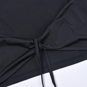 Close-up of black knit fabric detail with side lace-up drawstring and fine stitching