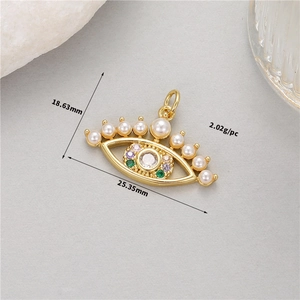 Macro view of 14K gold plated Evil Eye charm with pearls and crystals with dimensions