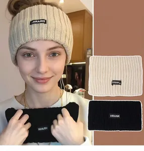 Detail showing cream and black knitted headband texture and Korean style woven labels