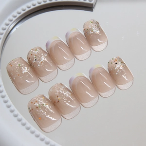 Short square press-on nails with nude French tips and sparkling colorful glitter sequins