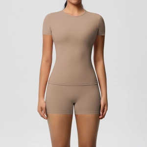 Detail of slim fit seamless yoga set featuring short sleeve T-shirt and high waist shorts