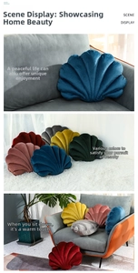 Detailed plush velvet shell cushions on a grey sofa and carpet in a cozy living room decor